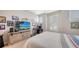 Comfortable bedroom with plantation shutters, tv, and rustic wood dresser at 11200 Whimbrel Ln, Sarasota, FL 34238