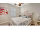Bright bedroom featuring a ceiling fan, a window with white shutters, and coastal-themed decor at 11200 Whimbrel Ln, Sarasota, FL 34238