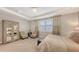 Bedroom featuring plush carpet, tray ceiling, neutral colors, and large window at 11200 Whimbrel Ln, Sarasota, FL 34238
