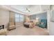 Bright bedroom with tray ceiling, plantation shutters, ceiling fan and calming color palette at 11200 Whimbrel Ln, Sarasota, FL 34238