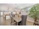 Open concept dining room with an elegant chandelier, adjacent to the kitchen at 11200 Whimbrel Ln, Sarasota, FL 34238