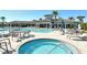 Relaxing community hot tub and pool area on a sunny day at 11200 Whimbrel Ln, Sarasota, FL 34238