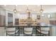 A stunning kitchen island with modern barstools, chic pendant lighting, and stainless steel appliances at 11200 Whimbrel Ln, Sarasota, FL 34238