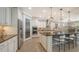 Modern kitchen featuring a large center island with barstool seating, stainless steel appliances, and white cabinetry at 11200 Whimbrel Ln, Sarasota, FL 34238