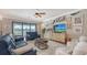 Living room boasts sliding doors to the pool, a modern TV console, and comfortable seating at 11200 Whimbrel Ln, Sarasota, FL 34238