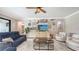Cozy living room featuring comfortable seating, a stylish coffee table, and unique wall decor at 11200 Whimbrel Ln, Sarasota, FL 34238