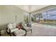 Screened patio features a grill and chairs with a pool view at 11200 Whimbrel Ln, Sarasota, FL 34238