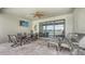 Screened patio with an outdoor dining area and seating, including a grill at 11200 Whimbrel Ln, Sarasota, FL 34238