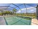 The screened pool overlooks the water and surrounding community at 11200 Whimbrel Ln, Sarasota, FL 34238