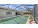 Home's screened pool overlooks the water and has outdoor seating and a grill at 11200 Whimbrel Ln, Sarasota, FL 34238
