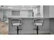 Kitchen bar top with seating and a view into the living space at 1150 Tarpon Center Dr # 1-C 103, Venice, FL 34285