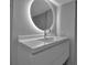 Modern bathroom showcasing a floating vanity, a round mirror with lights, and sleek fixtures at 1150 Tarpon Center Dr # 1-C 103, Venice, FL 34285