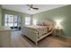 Comfortable bedroom with queen size bed and patio access through sliding glass doors at 1150 Tarpon Center Dr # 1-C 103, Venice, FL 34285