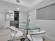 Bright dining area featuring glass table and modern lighting at 1150 Tarpon Center Dr # 1-C 103, Venice, FL 34285