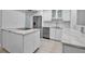 Modern kitchen featuring white cabinetry, stainless steel appliances, and marble countertops at 1150 Tarpon Center Dr # 1-C 103, Venice, FL 34285