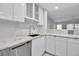 Well-lit kitchen featuring white cabinets, marble countertops, and stainless steel appliances at 1150 Tarpon Center Dr # 1-C 103, Venice, FL 34285