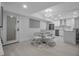 Bright, open-concept space combining the dining area and kitchen with sleek white cabinetry and modern appliances at 1150 Tarpon Center Dr # 1-C 103, Venice, FL 34285