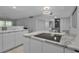 Open concept kitchen with an island cooktop, dining area and wine refrigerator at 1150 Tarpon Center Dr # 1-C 103, Venice, FL 34285