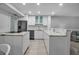 Modern kitchen featuring white cabinetry, stainless steel appliances, and marble countertops at 1150 Tarpon Center Dr # 1-C 103, Venice, FL 34285