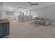 Spacious living room offering open layout to kitchen with modern bar seating and an adjacent dining area at 1150 Tarpon Center Dr # 1-C 103, Venice, FL 34285