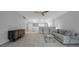 Bright living room featuring modern decor, light wood floors, and an adjacent dining area with bar seating at 1150 Tarpon Center Dr # 1-C 103, Venice, FL 34285