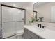 Modern bathroom with sleek glass shower, black hardware, and gray vanity with white countertop at 12017 Cranston Way, Bradenton, FL 34211