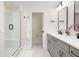 Modern bathroom with a glass-enclosed shower, double vanity, gray cabinets, and sleek black fixtures at 12017 Cranston Way, Bradenton, FL 34211