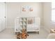 Cozy Bedroom featuring a white crib, natural light, and neutral decor at 12017 Cranston Way, Bradenton, FL 34211