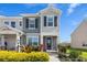 Charming two-story home with gray siding, black shutters, and lush landscaping at 12017 Cranston Way, Bradenton, FL 34211
