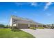 Three-car garage on a home with a meticulously manicured lawn and landscaping at 12017 Cranston Way, Bradenton, FL 34211