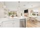 Modern kitchen with white cabinets, stainless steel appliances, and an open view to living spaces at 12017 Cranston Way, Bradenton, FL 34211