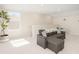 Neutral living room with lots of light, a comfortable gray sofa and white trim at 12017 Cranston Way, Bradenton, FL 34211