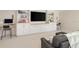 Entertainment room with built-in shelving, large TV, and comfortable gray couch at 12017 Cranston Way, Bradenton, FL 34211