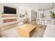 Open living space with modern fireplace feature, dining area, and kitchen island with bar stools at 12017 Cranston Way, Bradenton, FL 34211