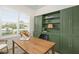 Bright office space with modern desk, custom green built-ins, and ample natural light at 12017 Cranston Way, Bradenton, FL 34211