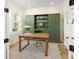 Stylish office with a wooden desk, a comfortable chair, and floor to ceiling built-in shelving at 12017 Cranston Way, Bradenton, FL 34211