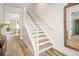 Bright stairway with light wood floors and white railings, seamlessly connecting the home's levels at 12017 Cranston Way, Bradenton, FL 34211
