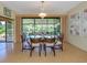 Open dining room with glass table, bright light fixture, and sliding glass doors to the backyard at 154 Inlets Blvd, Nokomis, FL 34275