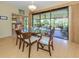 Bright dining area with glass table and sliding glass doors to the outdoor patio at 154 Inlets Blvd, Nokomis, FL 34275