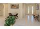 Bright foyer with decorative tile, double front doors, bench, and plenty of closet space at 154 Inlets Blvd, Nokomis, FL 34275