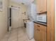 The laundry room offers updated appliances, extra counter space, and a door to the exterior of the home at 154 Inlets Blvd, Nokomis, FL 34275
