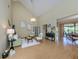 View of the living room with high ceilings, fan, adjacent dining room, and bamboo flooring at 154 Inlets Blvd, Nokomis, FL 34275