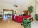 View of the open-concept living room with high ceilings, fan, adjacent dining room, and bamboo flooring at 154 Inlets Blvd, Nokomis, FL 34275