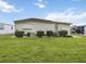 View of the back of the home with a well-maintained lawn and minimal landscaping at 170 Edgewood Dr, Osprey, FL 34229