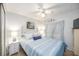 Cozy bedroom featuring a ceiling fan, bedside tables, and a comfortable bed with blue accents at 170 Edgewood Dr, Osprey, FL 34229