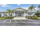 Community clubhouse with palm trees and a 'Fire Lane' parking area, perfect for gatherings at 170 Edgewood Dr, Osprey, FL 34229