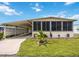 Charming home featuring a covered carport, screened-in porch, and well-manicured lawn with landscaped planters at 170 Edgewood Dr, Osprey, FL 34229