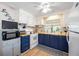 Cozy kitchen featuring white appliances, bright cabinetry, wood countertop, and a sink beneath a sunlit window at 170 Edgewood Dr, Osprey, FL 34229