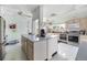 A well lit kitchen with stainless steel appliances, large island and plenty of counter space at 170 Edgewood Dr, Osprey, FL 34229