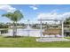 Lakeside bench swing overlooking a serene pond with a fountain, perfect for relaxation at 170 Edgewood Dr, Osprey, FL 34229